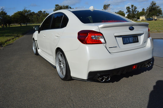 Rear angle view Subaru WRX with aftermarket side skirts and rear diffuser body kit installed