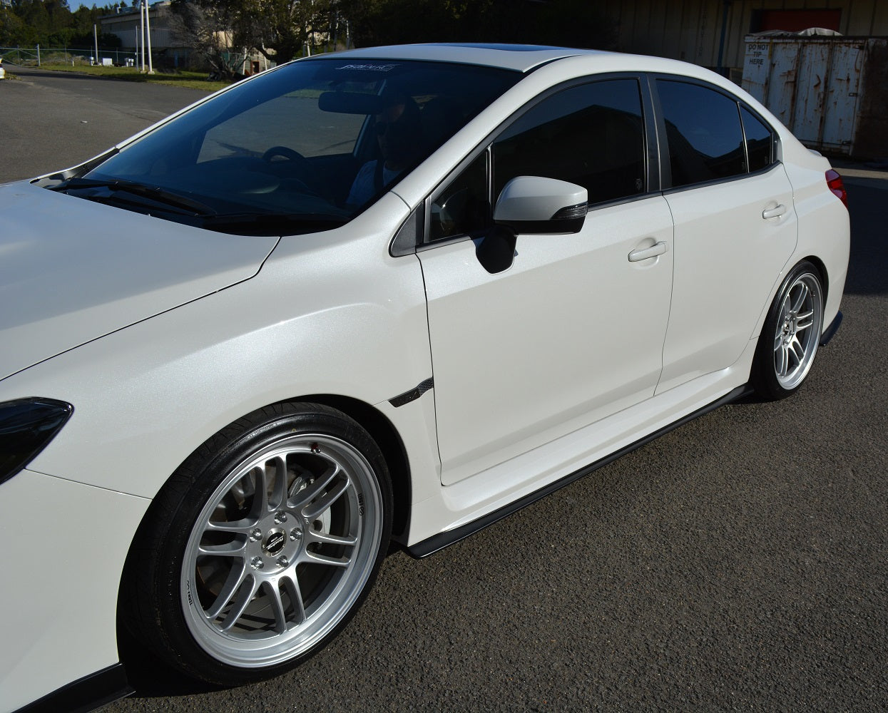 White Subaru WRX STI with JSAI Aero side skirts installed aftermarket body kit side view