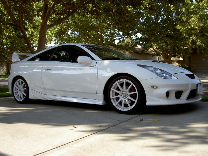 White Toyota Celica T23 with JSAI Aero front lip and side skirts aftermarket body kit front angle view

