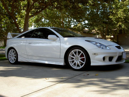 White Toyota Celica T23 with JSAI Aero front lip and side skirts aftermarket body kit front angle view
