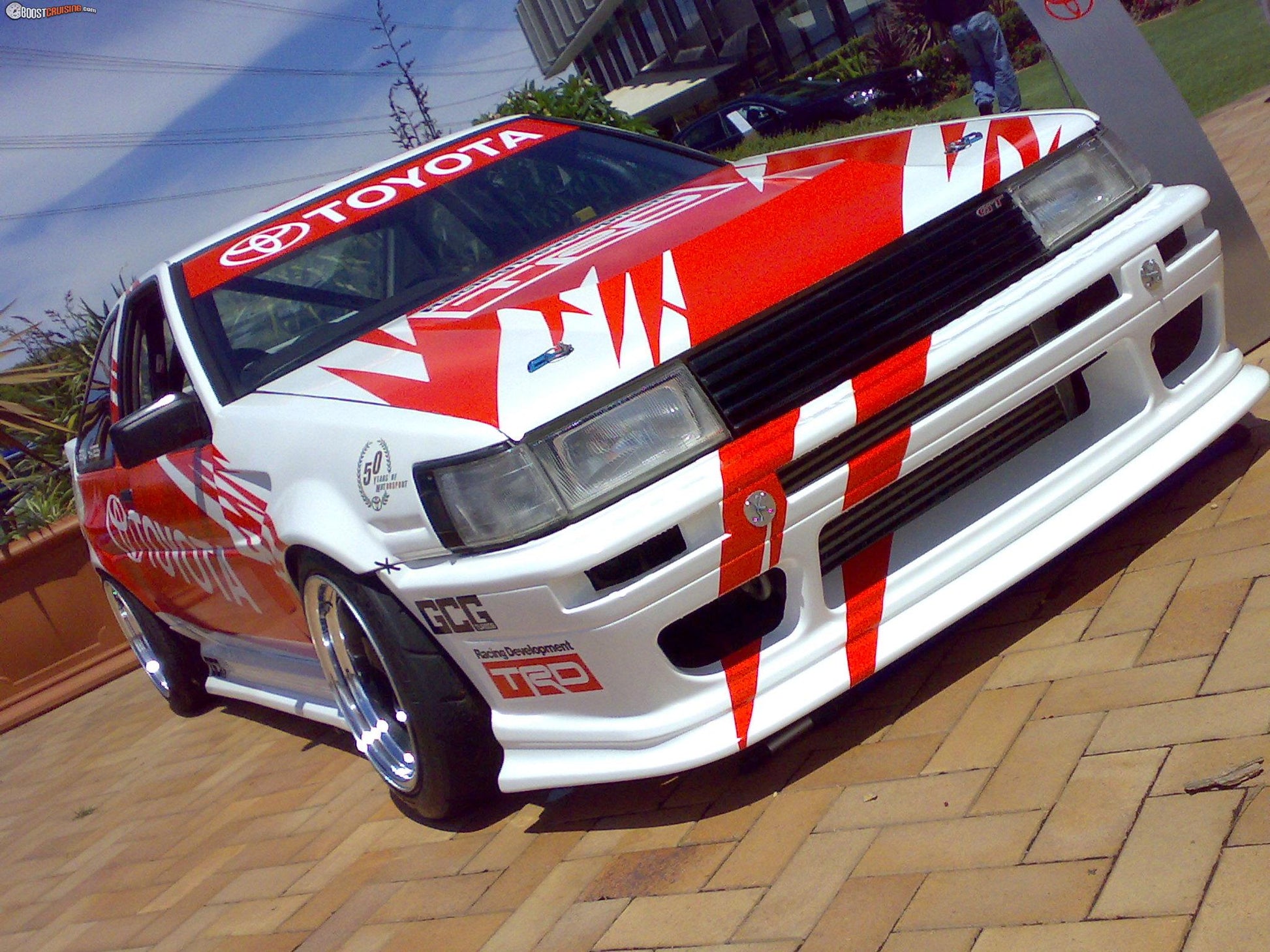 white Toyota Soarer with full body kit including front bumper and side skirts installed