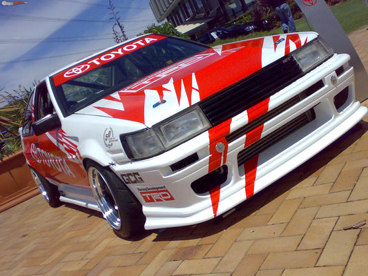 white Toyota Soarer with full body kit including front bumper and side skirts installed