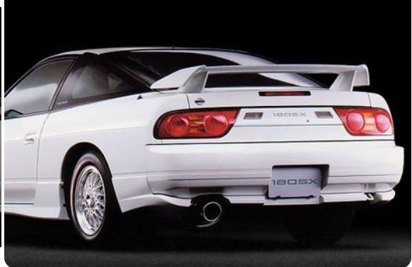 Rear view of a white Nissan 180SX with factory rear wing and stock body styling