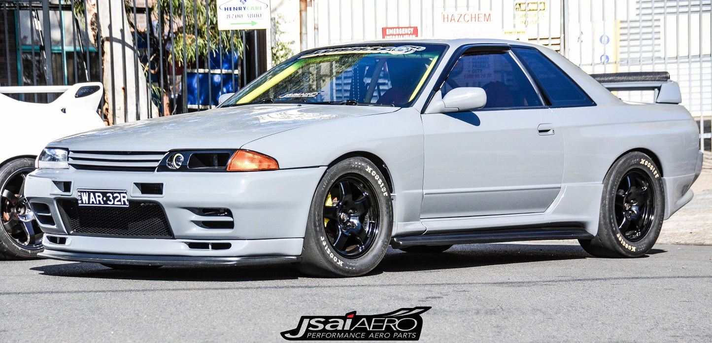 White Nissan Skyline R32 with JSAI Aero side skirts, front bar, and black wheels parked outdoors