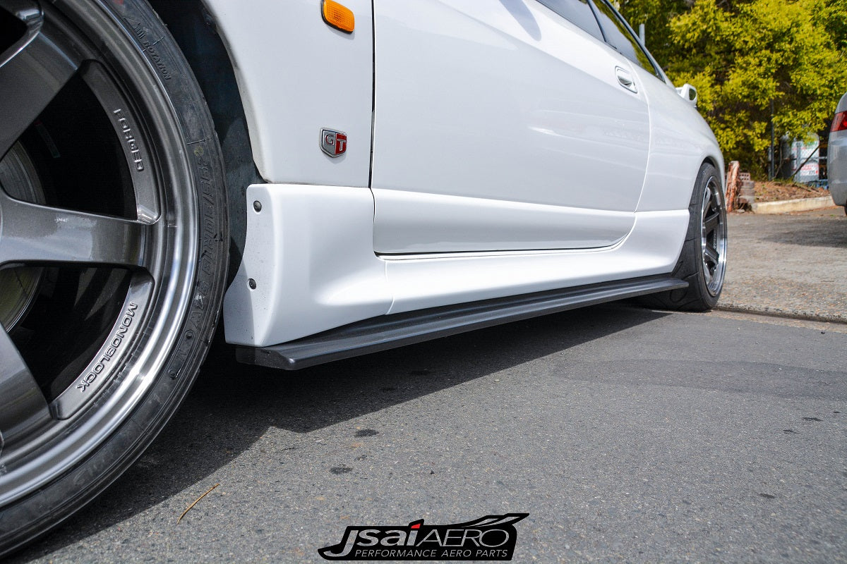 Close-up of JSAI Aero side skirt and splitter extension fitted to a white Nissan Skyline R33 GT-R